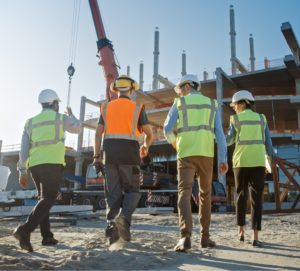 Construction workers walking up to the site