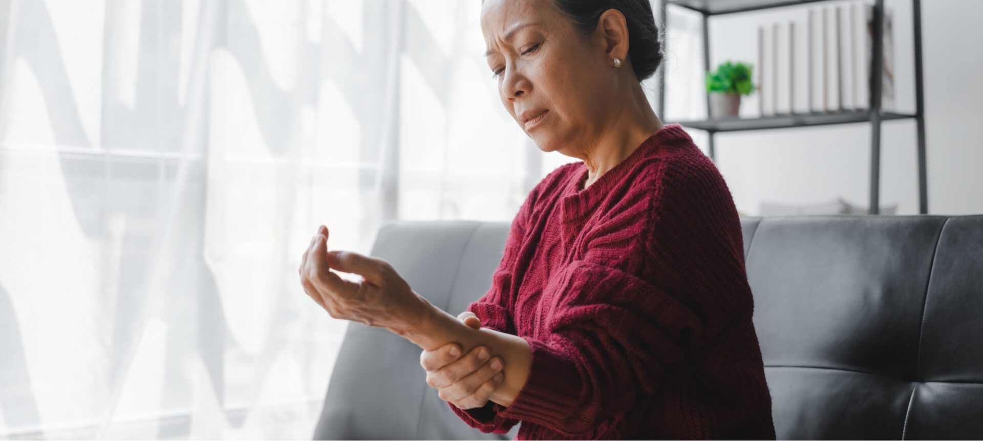 A woman looking at her arm after an injury