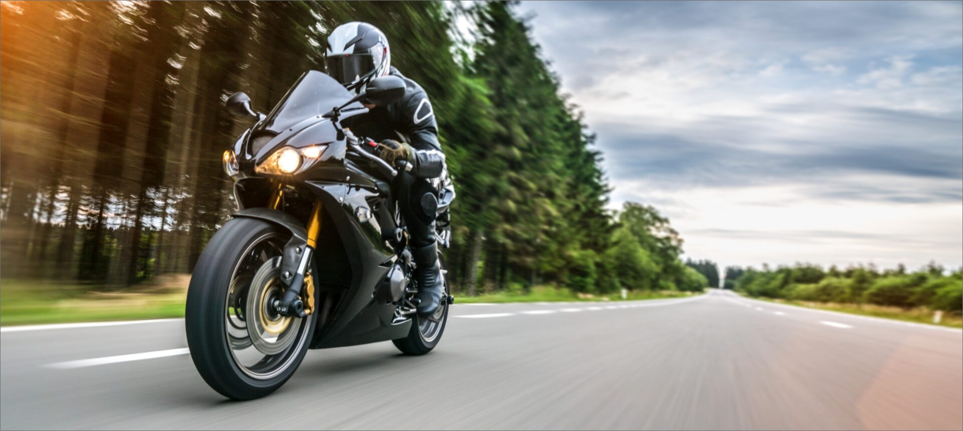 A motorcycle driving on the roadway during the day